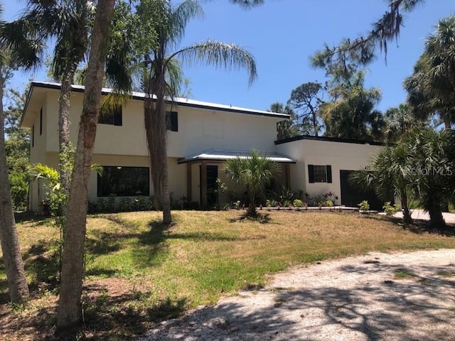 view of front of property with a front lawn and stucco siding
