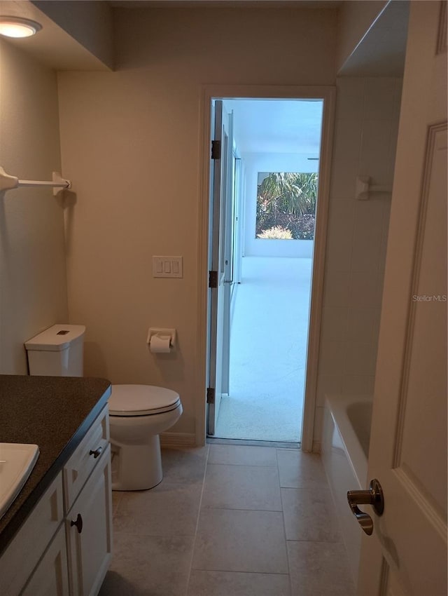 bathroom with vanity, toilet, and tile patterned flooring
