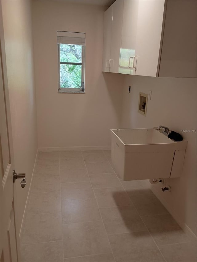 laundry room with hookup for an electric dryer, cabinet space, hookup for a washing machine, and light tile patterned flooring
