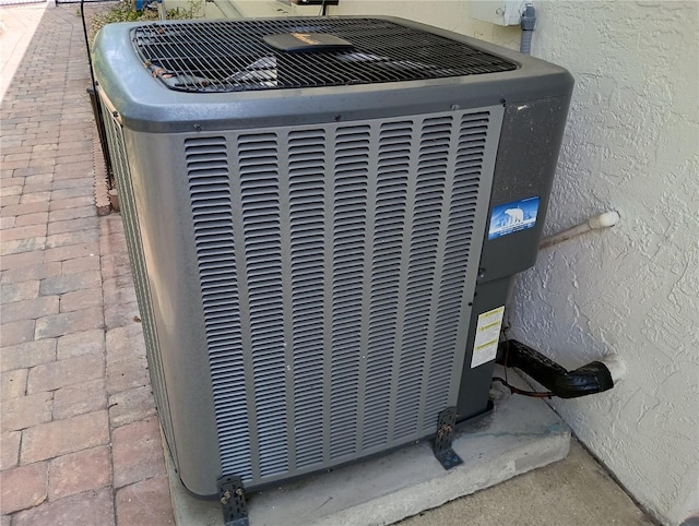 exterior details featuring stucco siding and central AC unit