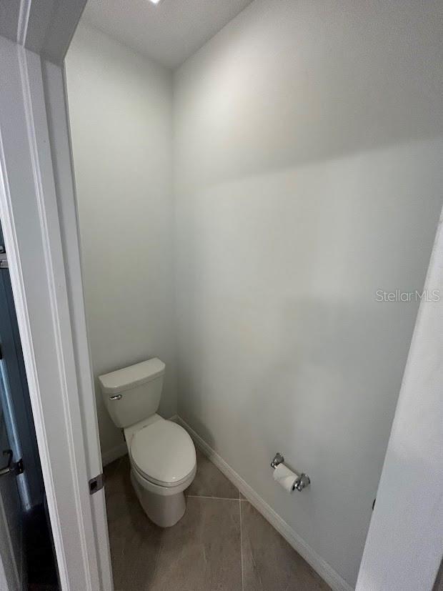 15968 Honeysuckle St, Port Charlotte, FL 33953 - bathroom with toilet and baseboards