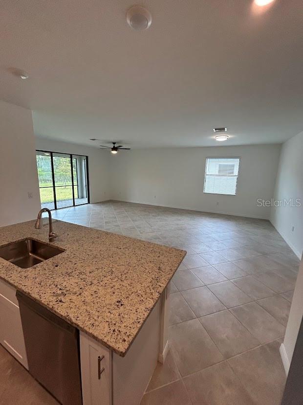 15968 Honeysuckle St, Port Charlotte, FL 33953 - kitchen with a sink, dishwasher, plenty of natural light, and open floor plan