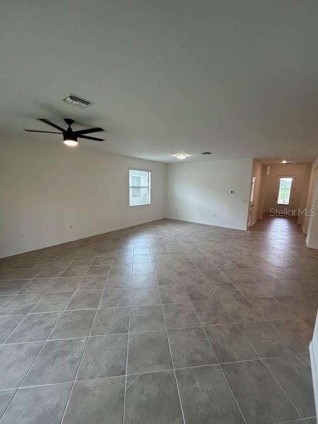 15968 Honeysuckle St, Port Charlotte, FL 33953 - tiled empty room featuring ceiling fan