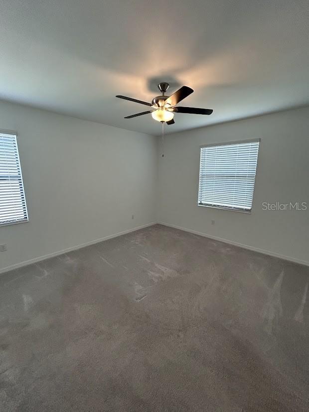 15968 Honeysuckle St, Port Charlotte, FL 33953 - carpeted spare room with ceiling fan and baseboards