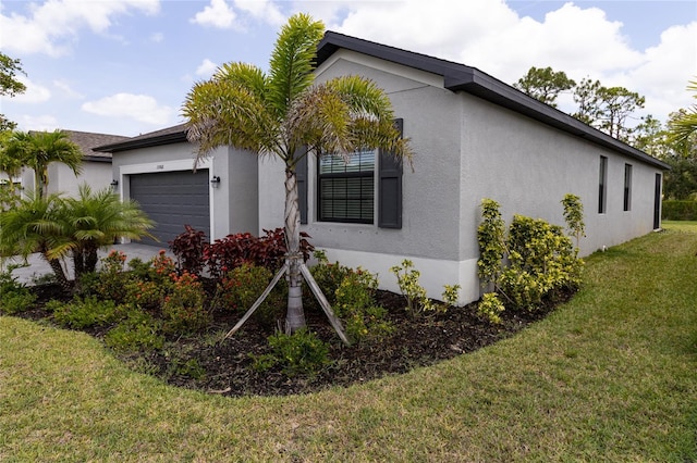 15968 Honeysuckle St, Port Charlotte, FL 33953 - view of home's exterior featuring stucco siding, an attached garage, and a lawn