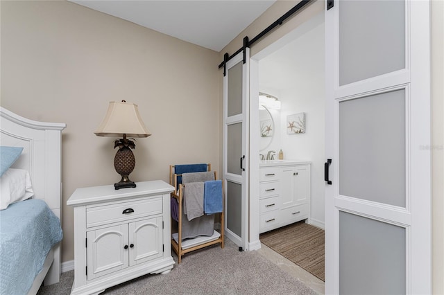 1551 Beach Rd Unit 412, Englewood, FL 34223 - bedroom featuring baseboards, a barn door, and carpet floors