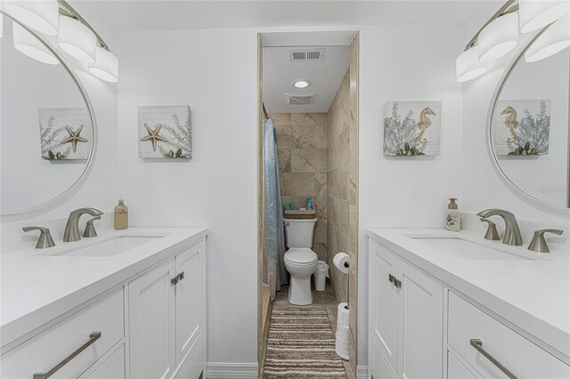 1551 Beach Rd Unit 412, Englewood, FL 34223 - full bath featuring two vanities and toilet