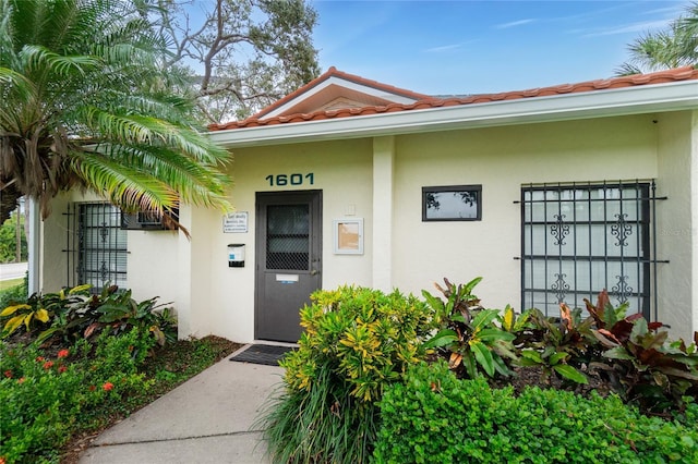 1551 Beach Rd Unit 412, Englewood, FL 34223 - property entrance featuring stucco siding and a tiled roof