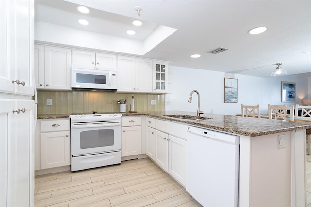 301 S Gulf Blvd Unit 419, Placida, FL 33946 - kitchen featuring a sink, a peninsula, white appliances, visible vents, and white cabinets