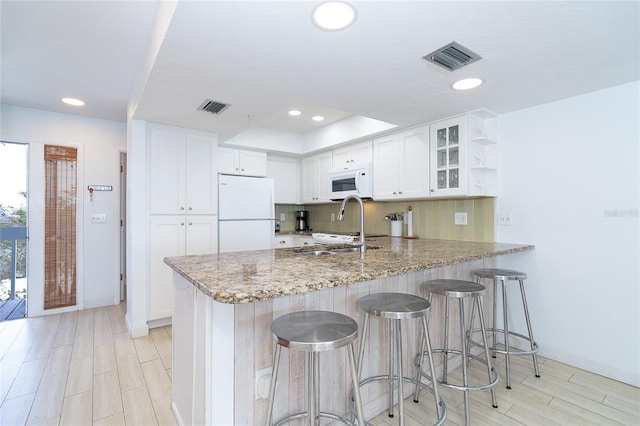 301 S Gulf Blvd Unit 419, Placida, FL 33946 - kitchen with white appliances, visible vents, white cabinets, and a peninsula
