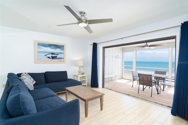 301 S Gulf Blvd Unit 419, Placida, FL 33946 - living area featuring a water view, light wood-type flooring, and a ceiling fan