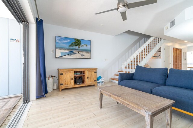 301 S Gulf Blvd Unit 419, Placida, FL 33946 - living area with visible vents, light wood-style flooring, stairway, and a ceiling fan