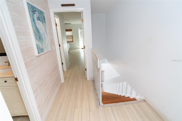 301 S Gulf Blvd Unit 419, Placida, FL 33946 - hallway featuring stairs, light wood-type flooring, an upstairs landing, and baseboards