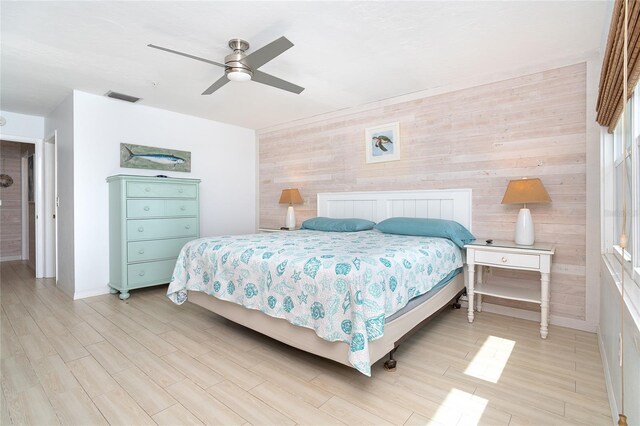 301 S Gulf Blvd Unit 419, Placida, FL 33946 - bedroom featuring wood walls, visible vents, light wood finished floors, baseboards, and a ceiling fan