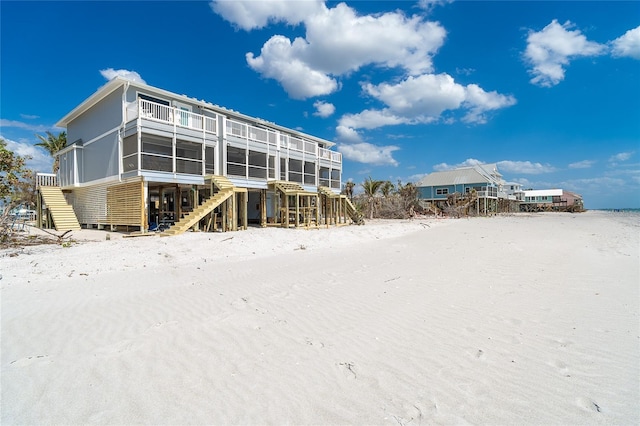 301 S Gulf Blvd Unit 419, Placida, FL 33946 - snow covered rear of property with a sunroom and stairway