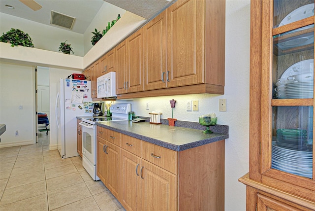 1078 Boundary Blvd, Rotonda West, FL 33947 - kitchen with white appliances, dark countertops, and light tile patterned floors