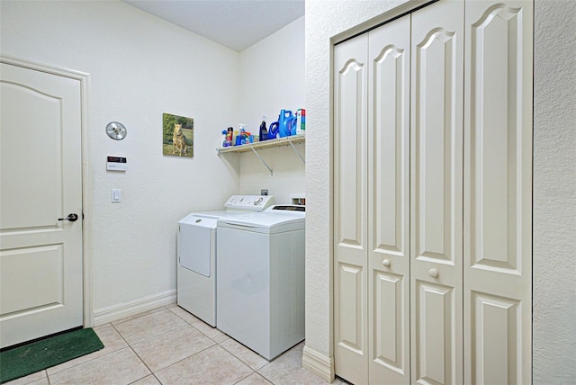 1078 Boundary Blvd, Rotonda West, FL 33947 - laundry room featuring separate washer and dryer, light tile patterned flooring, and baseboards