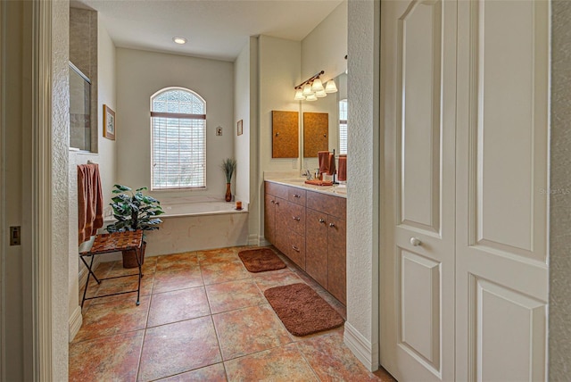 1078 Boundary Blvd, Rotonda West, FL 33947 - bathroom featuring vanity, a garden tub, a shower with shower door, and tile patterned floors