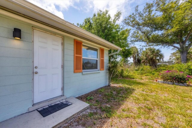 view of exterior entry with concrete block siding