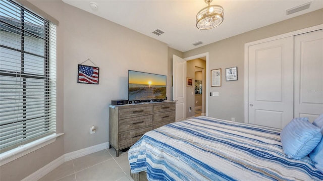 2117 Laurifolia Ct, North Port, FL 34289 - bedroom with baseboards, visible vents, and light tile patterned flooring