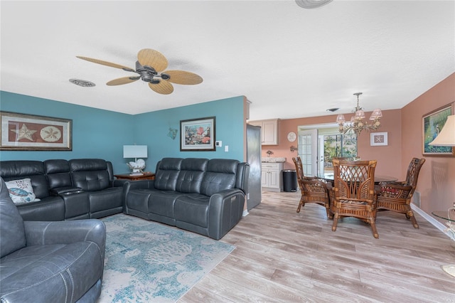 1670 Faust Dr, Englewood, FL 34224 - living room featuring light wood-type flooring and ceiling fan with notable chandelier
