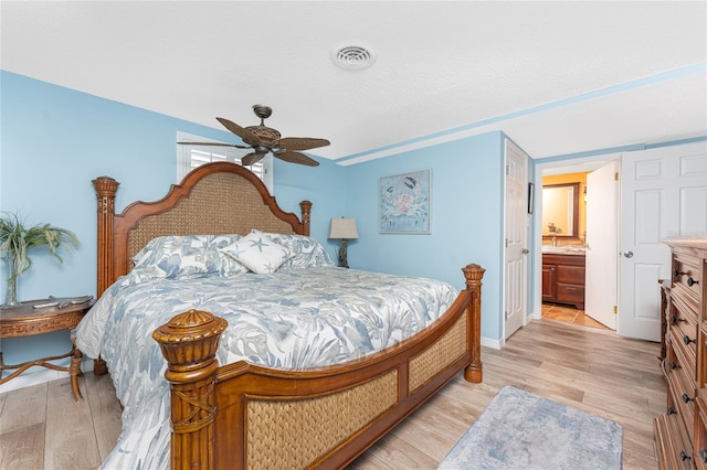 1670 Faust Dr, Englewood, FL 34224 - bedroom featuring ensuite bathroom, light wood-type flooring, a ceiling fan, visible vents, and baseboards
