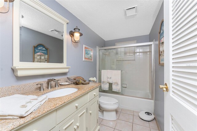 1670 Faust Dr, Englewood, FL 34224 - bathroom with vanity, enclosed tub / shower combo, tile patterned flooring, toilet, and visible vents