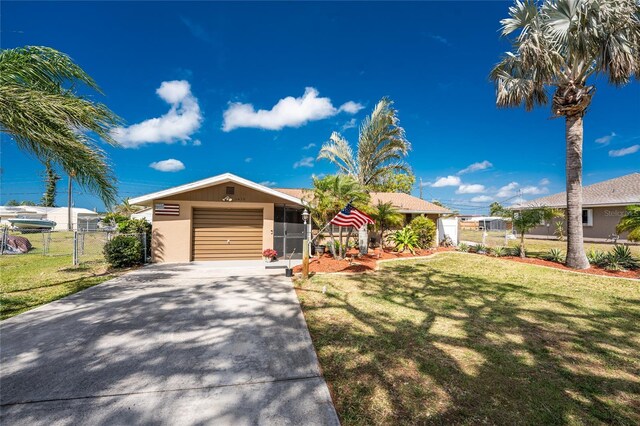 1670 Faust Dr, Englewood, FL 34224 - view of front of property featuring fence, a front lawn, a gate, an attached garage, and concrete driveway