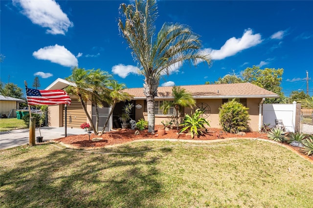 1670 Faust Dr, Englewood, FL 34224 - ranch-style house featuring a front yard, driveway, stucco siding, and fence