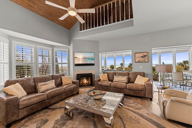 17 Seawatch Dr, Boca Grande, FL 33921 - living room featuring plenty of natural light, a ceiling fan, a glass covered fireplace, and high vaulted ceiling