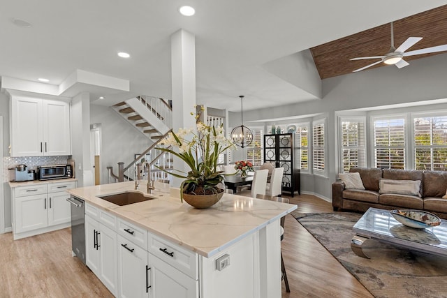 17 Seawatch Dr, Boca Grande, FL 33921 - kitchen featuring a sink, ceiling fan with notable chandelier, open floor plan, dishwasher, and a center island with sink