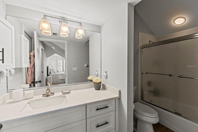 17 Seawatch Dr, Boca Grande, FL 33921 - ensuite bathroom with vaulted ceiling, toilet, vanity, bath / shower combo with glass door, and ensuite bathroom