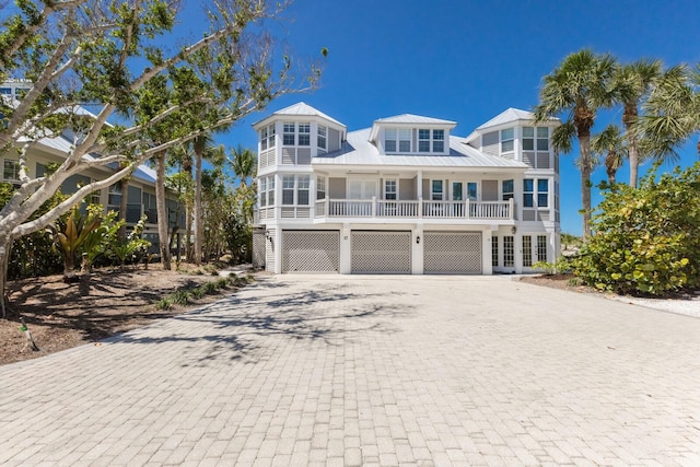 17 Seawatch Dr, Boca Grande, FL 33921 - beach home with metal roof, a standing seam roof, a garage, and decorative driveway