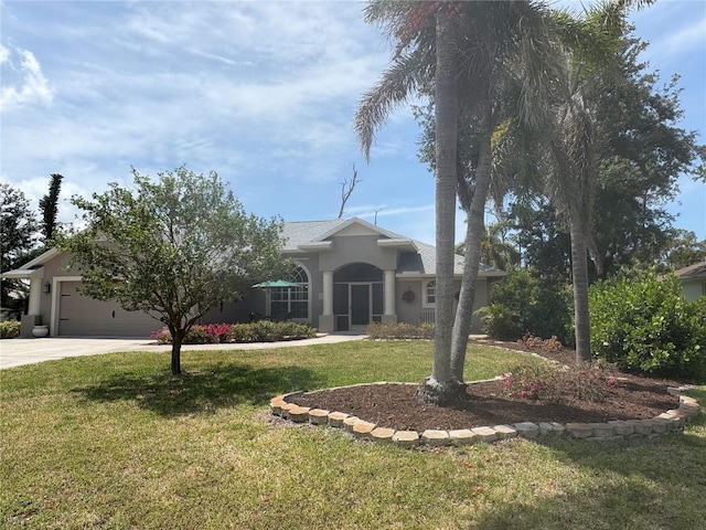 941 Elwood Ave, Englewood, FL 34223 - view of front of home with concrete driveway, an attached garage, a front lawn, and stucco siding