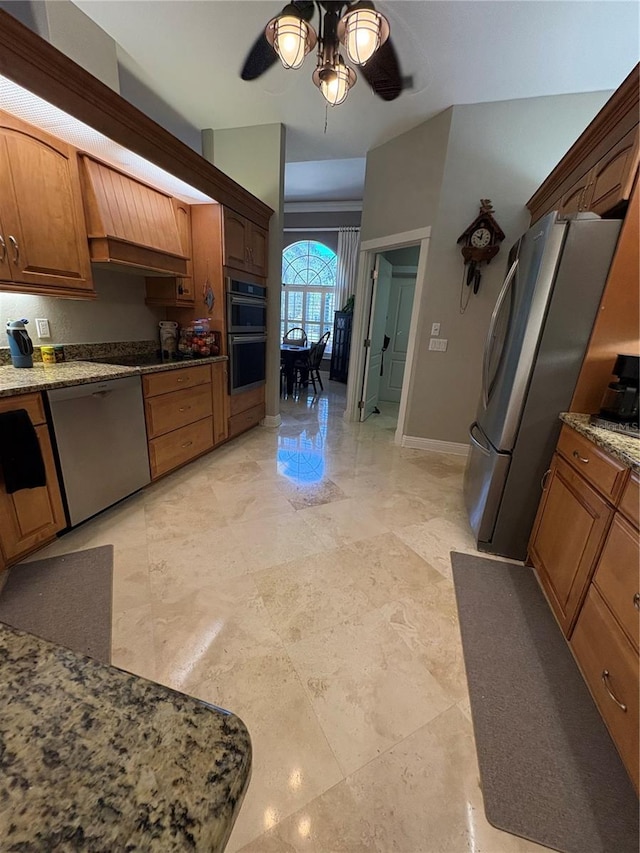 941 Elwood Ave, Englewood, FL 34223 - kitchen featuring appliances with stainless steel finishes, a ceiling fan, light stone countertops, and brown cabinets