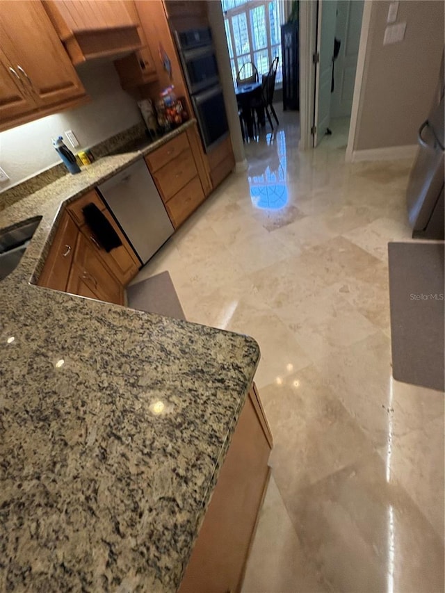 941 Elwood Ave, Englewood, FL 34223 - kitchen featuring light stone counters, brown cabinetry, and stainless steel double oven