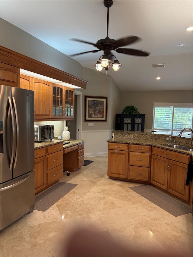 941 Elwood Ave, Englewood, FL 34223 - kitchen featuring stainless steel refrigerator with ice dispenser, a ceiling fan, brown cabinetry, glass insert cabinets, and recessed lighting