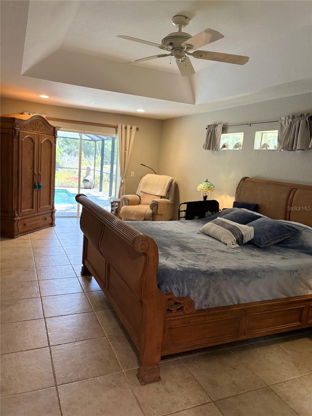 941 Elwood Ave, Englewood, FL 34223 - bedroom with a tray ceiling, access to exterior, light tile patterned flooring, recessed lighting, and a ceiling fan