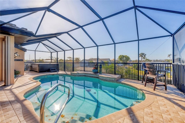 pool featuring glass enclosure, a hot tub, and a patio