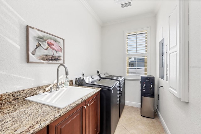 laundry room featuring crown molding, a sink, separate washer and dryer, cabinet space, and visible vents