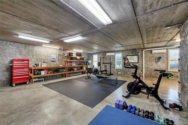 exercise area featuring a wall mounted AC