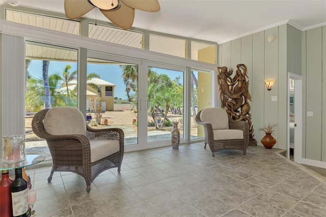 sitting room with a healthy amount of sunlight, a ceiling fan, and ornamental molding