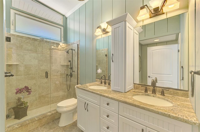 full bath with toilet, a sink, ornamental molding, and a stall shower