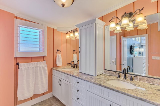 bathroom featuring a sink, a chandelier, double vanity, and crown molding