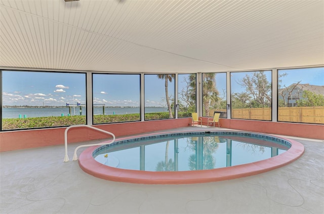 view of swimming pool featuring a water view