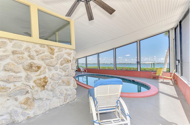 view of swimming pool featuring a water view, a hot tub, and ceiling fan