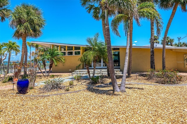 view of front of house with a patio area and stucco siding