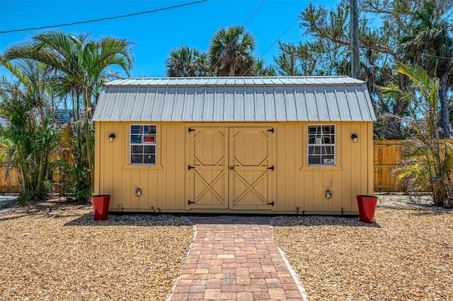 view of shed featuring fence