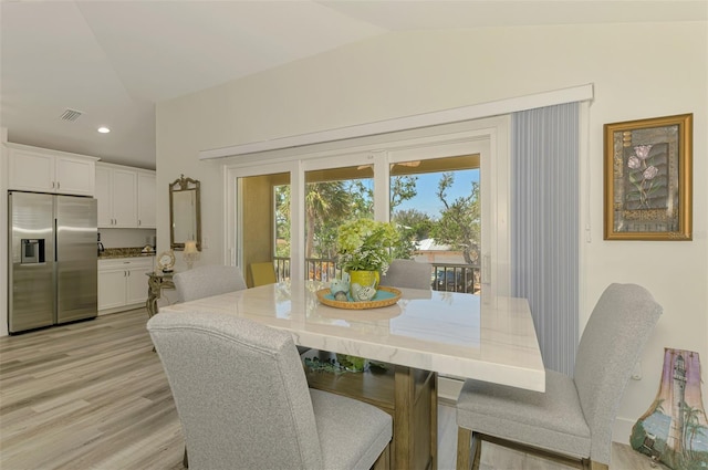 dining room featuring recessed lighting, lofted ceiling, visible vents, and light wood-type flooring