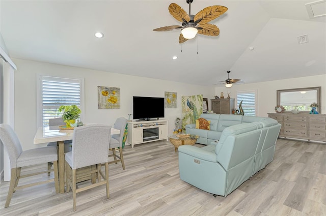 living room with lofted ceiling, a ceiling fan, and light wood finished floors